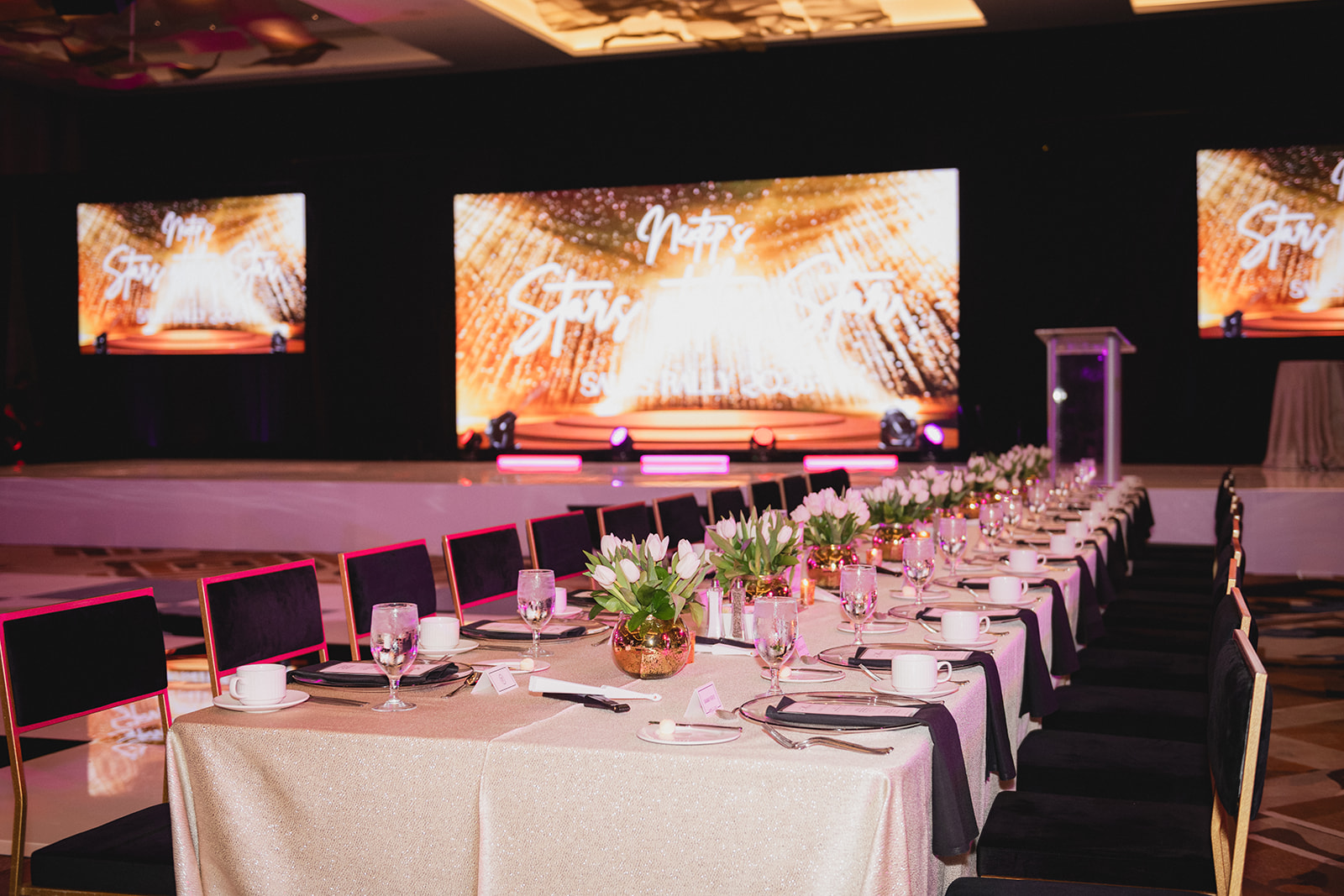 Vast Vision Productions event setup with ballroom tables, stage lighting, and video displays